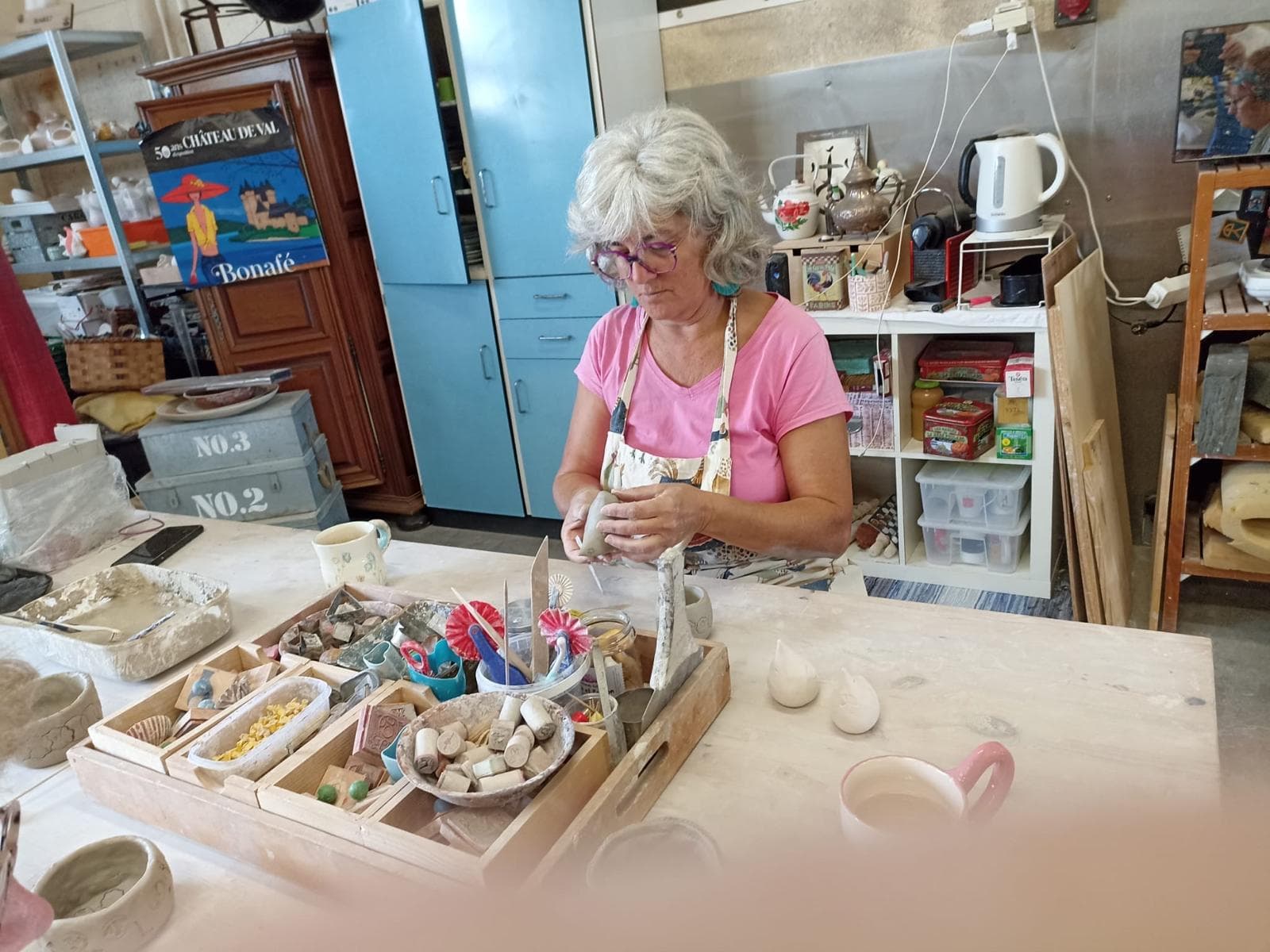 Craftswoman shaping clay on a potter's wheel